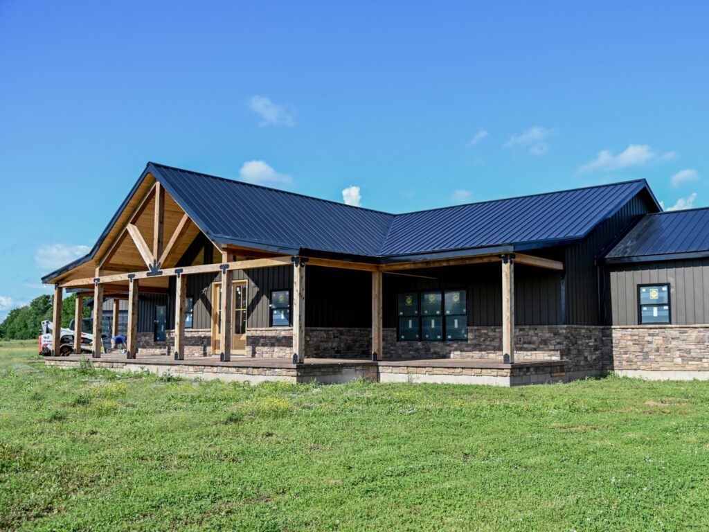 Photo of barndominium with black roof and charcoal siding